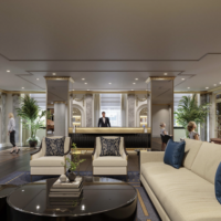 a lobby with a man standing behind a reception desk